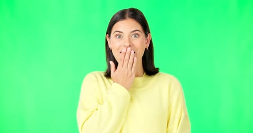 Shock, surprise and face of woman on green screen for news, announcement and information in studio
