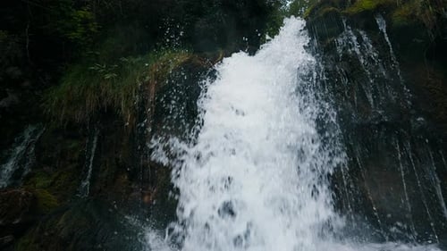 Flowing and Splashing Water of Mountain Waterfall Slow Motion Shot