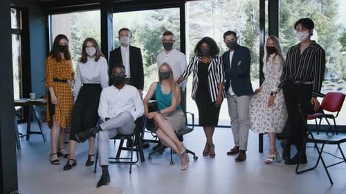 Diverse Team Posing with Face Masks in Office