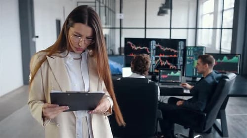 Team of stockbrokers works together in modern office at daytime