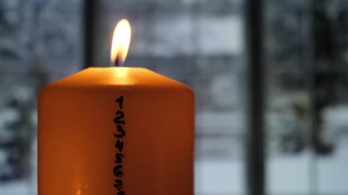 Burning Candle with Numbers During Wintertime Holiday Season