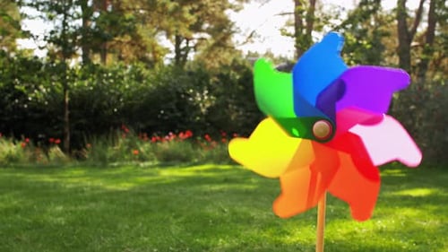 Colorful pinwheel turns in summer breeze a sustainable energy source for the future