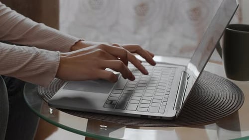 Woman Hands Typing on a Laptop at Home