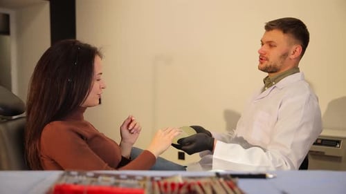 Doctor Consults with Patient About Silicone Implants