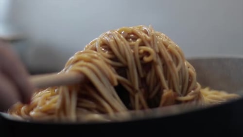 Stirring Creamy Spaghetti in Frying Pan Close-Up