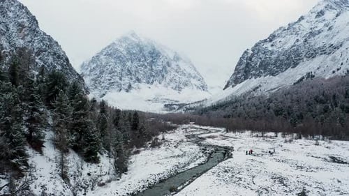 Aerial view of snow-covered mountains and river, Russia.