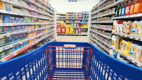 Shopping Cart POV in Supermarket Aisle with Groceries