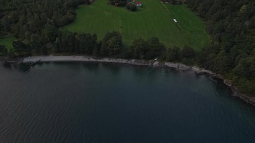 Mardalsfossen waterfall drops from cliffside at dawn, drone view Norway