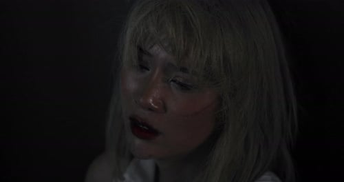 The abducted woman's wrists and feet are bound in red rope, with no way to fight or resist. Female h