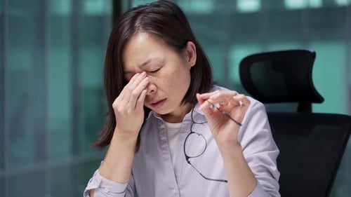 Business Woman Experiencing Eye Strain at the Office