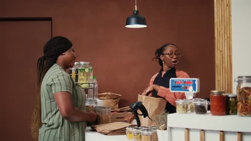 African American Buyer Paying with Card at Pos in Eco Store