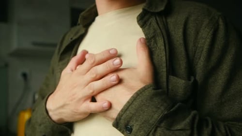 Man Holding Chest Experiencing Heart Attack or Stroke Symptoms