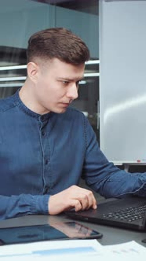 Vertical Screen Businessman Typing on Laptop in Office