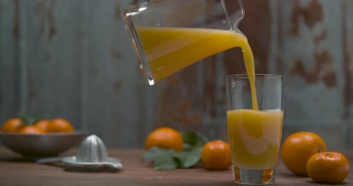 Fresh Orange Juice Being Poured Into Glass
