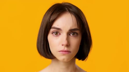 Sad Young Woman with Tears in Her Eyes