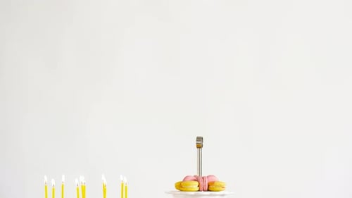 Birthday cake and desserts on table, white background