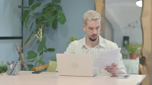 Young Adult Working at Computer in Office