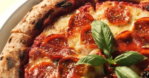 Delicious Pepperoni Pizza Close-Up with Fresh Basil