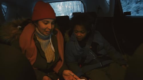 Woman and Child Use Tablet in Car on Winter Roadtrip