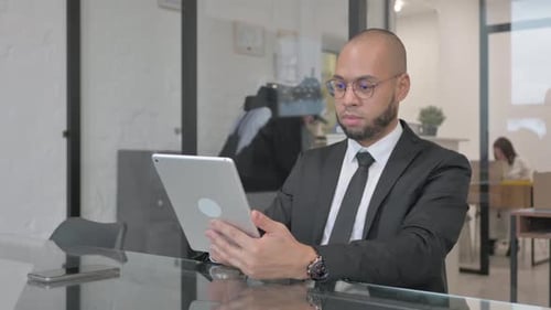 Mixed Race Businessman Using Digital Tablet