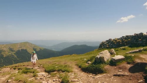 Hiker Enjoying Mountain Vista Lone Hiker Walking on a Mountain Trail with a Vast Landscape in the