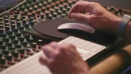 Sound technician working on audio mixer