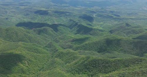 High Altitude Aerial View Rolling Green Hills Forest Landscape