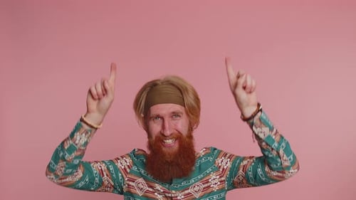 Hippie Man Showing Thumbs Up and Pointing Empty Place Advertising Area for Commercial Text Promotion
