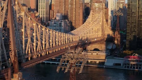 Aerial view of the Queensboro Bridge with the Manhattan skyline in the background.