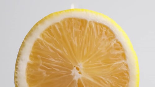 Water Pours on Fresh Lemon Close Up