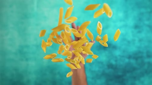 Hand Throws Raw Pasta in Slow Motion