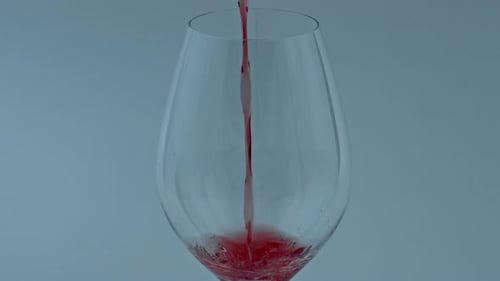 Pouring Red Liquid into a Wine Glass