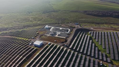 Solar panel installation in a large field under clear sky
