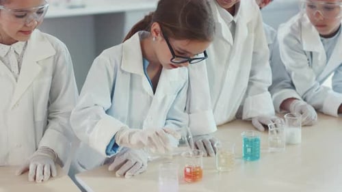 Children Conducting Colorful Science Experiment in Classroom
