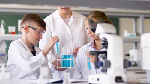 Enthusiastic Children Doing Science Experiment in Class