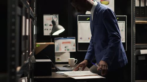 Detective Inspecting Evidence in Office