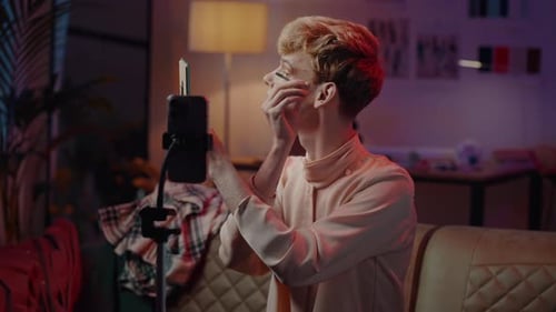 Transgender Male Records Makeup Video Tutorial on His Smartphone Mount in Tripod Gender Expression