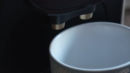 Coffee Machine Filling a Ceramic Mug with Coffee
