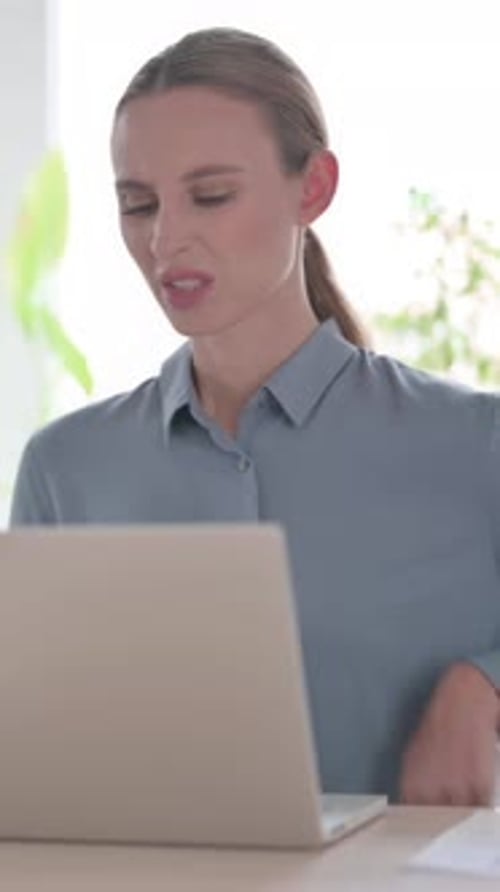 Woman having Back Pain while using Laptop in Office, Vertical Video