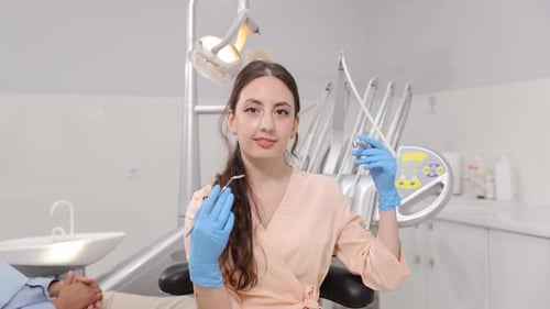 Female Dentist Holding Instruments in Modern Office