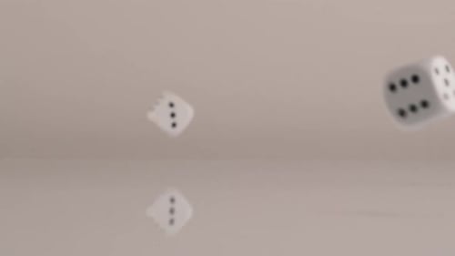 White Dice Tumbling in Slow Motion