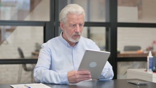 Old Businessman with Loss on Tablet in Office