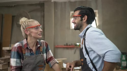 Carpenters are working together at workshop.