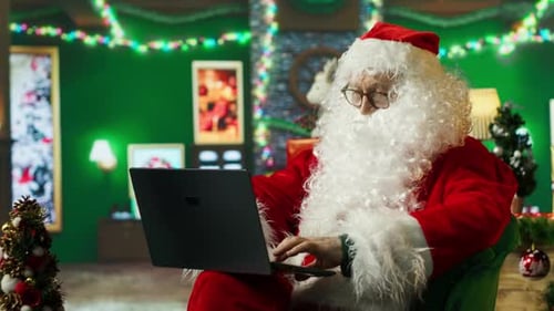 Santa Claus Using Laptop in Decorated Room