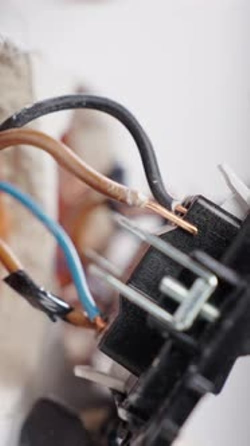Close up of electrical wiring component being repaired