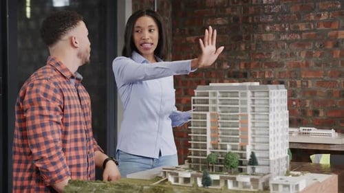 Architects Collaborate on Building Design in Modern Office