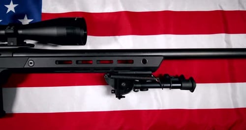 Rifle on American Flag Panning Shot