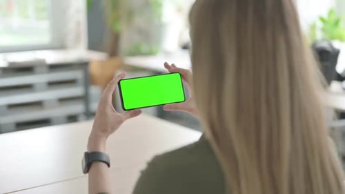 Blonde Woman Watching Smartphone with Green Screen