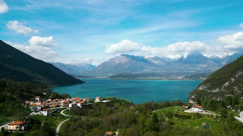 Aerial Drone Shot Going Forward Near De Lake Water with Impressive Mountains with Snow As a