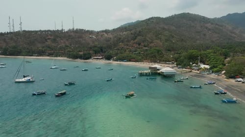 Aerial of Senggigi ferry terminal with boats floating peacefully in water